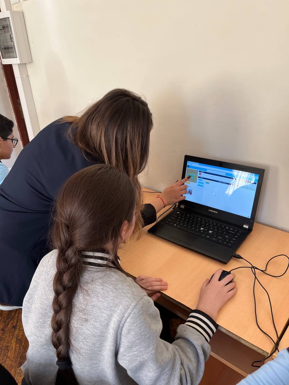 A student explaining to a child