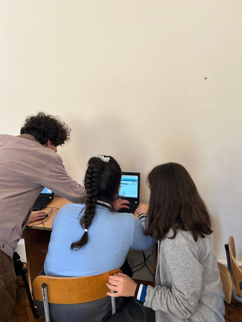 A student helping children